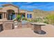 Outdoor kitchen with stonework and granite countertop at 11475 E Paradise Ln, Scottsdale, AZ 85255