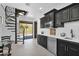 Modern kitchen with dark cabinetry and stainless steel appliances at 11475 E Paradise Ln, Scottsdale, AZ 85255