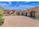 Three car garage with stone facade and driveway at 11475 E Paradise Ln, Scottsdale, AZ 85255