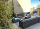 Patio with wicker furniture and a built-in fireplace at 38730 N Donovan Ln, Phoenix, AZ 85086