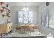 Virtually staged dining area with modern decor and wood table at 3704 W Vivian Ct, Phoenix, AZ 85086