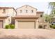 Front view of a two-story house with a tan facade and garage at 3704 W Vivian Ct, Phoenix, AZ 85086