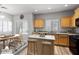 Virtually staged kitchen features light wood cabinets, granite counters, and an island at 3704 W Vivian Ct, Phoenix, AZ 85086