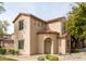 Tan two-story home with Spanish-style accents and landscaping at 3704 W Vivian Ct, Phoenix, AZ 85086