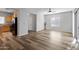 Open living room with laminate flooring and access to the kitchen at 3704 W Vivian Ct, Phoenix, AZ 85086