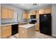 Kitchen with light wood cabinets, granite countertops and black appliances at 3704 W Vivian Ct, Phoenix, AZ 85086