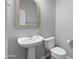 Small powder room with pedestal sink and decorative mirror at 3704 W Vivian Ct, Phoenix, AZ 85086