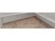 Walk-in pantry with white shelves and neutral tile flooring at 17065 W Molly Ln, Surprise, AZ 85387