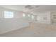 Spacious loft area with neutral carpeting and multiple windows at 17065 W Molly Ln, Surprise, AZ 85387
