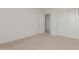 Bright bedroom with carpet and a door to hallway at 17065 W Molly Ln, Surprise, AZ 85387