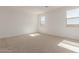 Well-lit bedroom with two windows and carpeted floor at 17065 W Molly Ln, Surprise, AZ 85387