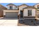 Two-story home with gray garage door at 17065 W Molly Ln, Surprise, AZ 85387