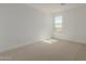 Spacious bedroom with neutral carpet and a window at 17065 W Molly Ln, Surprise, AZ 85387