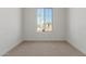 Simple bedroom with carpet flooring and window with view at 17065 W Molly Ln, Surprise, AZ 85387