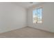 Bright bedroom with carpet flooring and large window at 17065 W Molly Ln, Surprise, AZ 85387