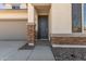 Modern front door with stone accents and a welcoming walkway at 17065 W Molly Ln, Surprise, AZ 85387