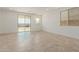 Bright living room with tile floors and sliding glass door to backyard at 17065 W Molly Ln, Surprise, AZ 85387
