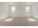 Bright bedroom with two large windows and carpet at 17065 W Molly Ln, Surprise, AZ 85387