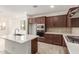 Modern kitchen with dark cabinets, stainless steel appliances and quartz countertops at 17065 W Molly Ln, Surprise, AZ 85387