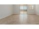 Spacious living room featuring tile floors and access to backyard at 17065 W Molly Ln, Surprise, AZ 85387
