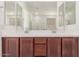 Bathroom boasts a double vanity and large mirror at 17065 W Molly Ln, Surprise, AZ 85387