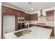 Spacious kitchen with dark cabinetry, stainless steel appliances, and quartz countertops at 17065 W Molly Ln, Surprise, AZ 85387