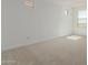 Well-lit bedroom with carpet and large window at 17065 W Molly Ln, Surprise, AZ 85387