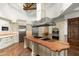 A bright kitchen with an oversized island and high ceilings at 5842 E Redwing Rd, Paradise Valley, AZ 85253