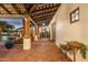 Brick covered patio with columns and access to pool area at 5842 E Redwing Rd, Paradise Valley, AZ 85253