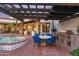 Brick outdoor kitchen with dining area under a pergola at 5842 E Redwing Rd, Paradise Valley, AZ 85253