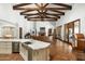 Open concept great room boasts wood beams, hardwood floors, and a cozy fireplace at 5842 E Redwing Rd, Paradise Valley, AZ 85253