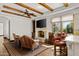 Cozy sitting area with fireplace and leather couches at 5842 E Redwing Rd, Paradise Valley, AZ 85253