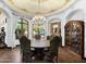 Formal dining room features a round table, chandelier, and decorative ceiling at 5842 E Redwing Rd, Paradise Valley, AZ 85253
