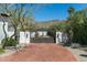 Elegant entry gate with brick driveway, leading to a beautiful home and mountain views at 5842 E Redwing Rd, Paradise Valley, AZ 85253