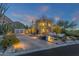 Desert landscape with house exterior at dusk at 10751 E Candlewood Dr, Scottsdale, AZ 85255