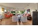 Comfortable living room with a large TV, ample seating, and hardwood floors at 10751 E Candlewood Dr, Scottsdale, AZ 85255