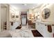 Elegant bathroom with and vanities, marble floors, and large mirrors at 10751 E Candlewood Dr, Scottsdale, AZ 85255