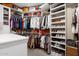Large walk-in closet with custom shelving and hanging space for shoes and clothes at 10751 E Candlewood Dr, Scottsdale, AZ 85255