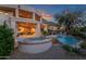 Stunning backyard oasis with a pool, spa, and firepit, perfect for entertaining at 10751 E Candlewood Dr, Scottsdale, AZ 85255