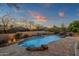 Freeform pool with mountain views and stone accents at 10751 E Candlewood Dr, Scottsdale, AZ 85255