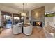 Open kitchen with a breakfast nook, stone fireplace, and access to a patio at 10751 E Candlewood Dr, Scottsdale, AZ 85255