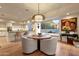 Modern kitchen with white cabinetry, granite countertops, and a breakfast bar at 10751 E Candlewood Dr, Scottsdale, AZ 85255