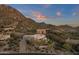 Aerial view showcasing the home's unique design and mountain backdrop at 10751 E Candlewood Dr, Scottsdale, AZ 85255