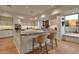 Spacious kitchen with granite island, ample cabinetry, and hardwood floors at 10751 E Candlewood Dr, Scottsdale, AZ 85255