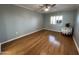 Bright bedroom with hardwood floors and a ceiling fan at 10330 W Thunderbird Blvd # C115, Sun City, AZ 85351