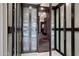 Modern closet with dark wood cabinets and glass doors at 7157 E Rancho Vista Dr # 3006, Scottsdale, AZ 85251