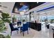 Bright dining area with a glass table, blue velvet chairs, and city views at 7157 E Rancho Vista Dr # 3006, Scottsdale, AZ 85251