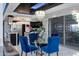 Elegant dining area with a glass table and four blue velvet chairs at 7157 E Rancho Vista Dr # 3006, Scottsdale, AZ 85251