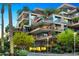 Modern multi-story building with private balconies and palm trees at 7157 E Rancho Vista Dr # 3006, Scottsdale, AZ 85251