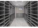Large walk-in closet with built-in storage and window at 29646 N 109Th Pl # 128, Scottsdale, AZ 85262